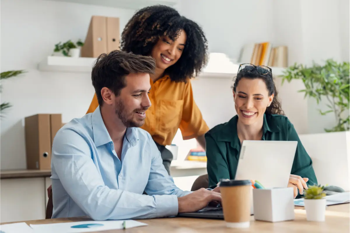 Business partners collaborating in an office while adding a new member to an LLC and planning business growth