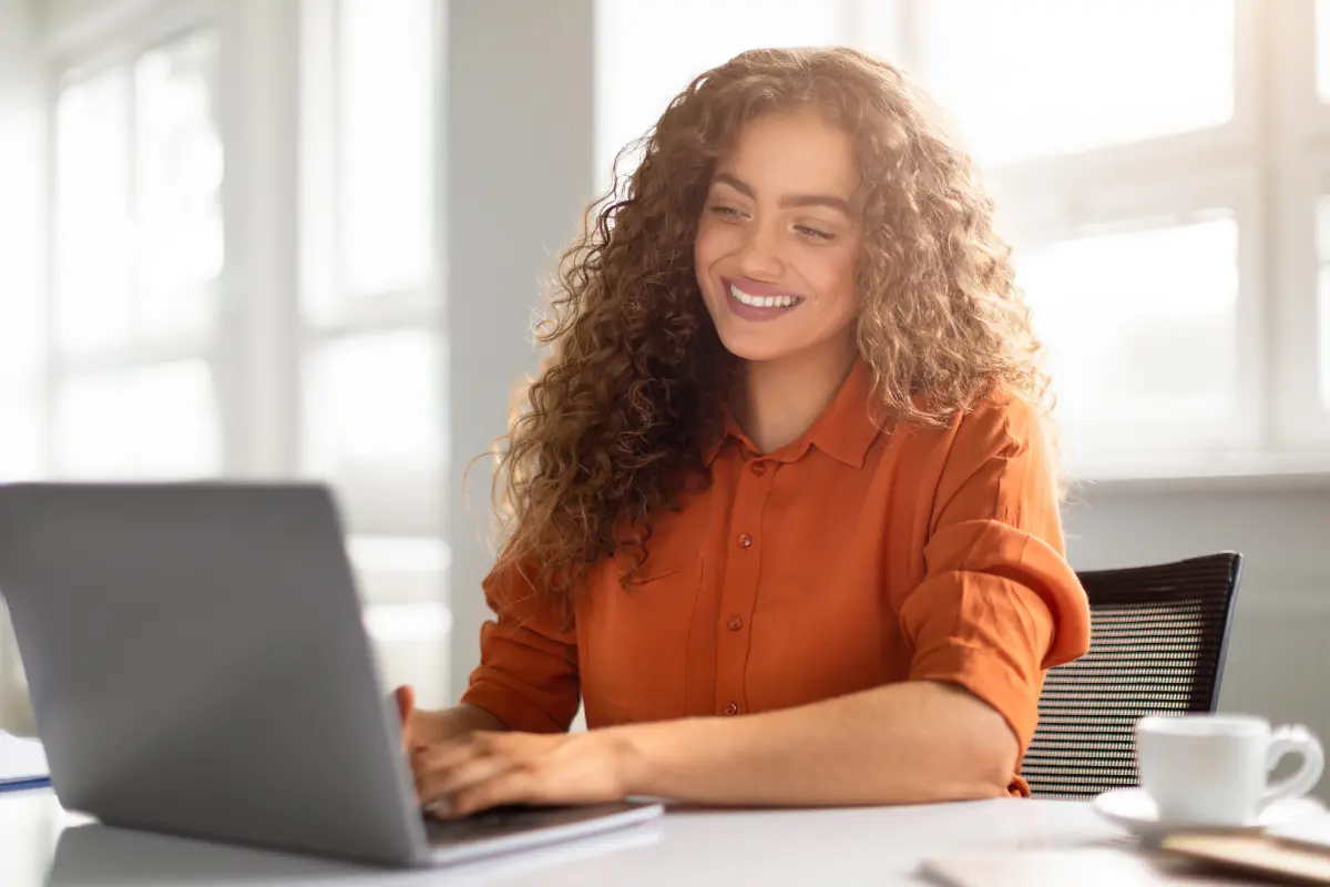 Small business owner researching whether she needs an LLC for her business on a laptop to understand the benefits of an LLC and when to form one