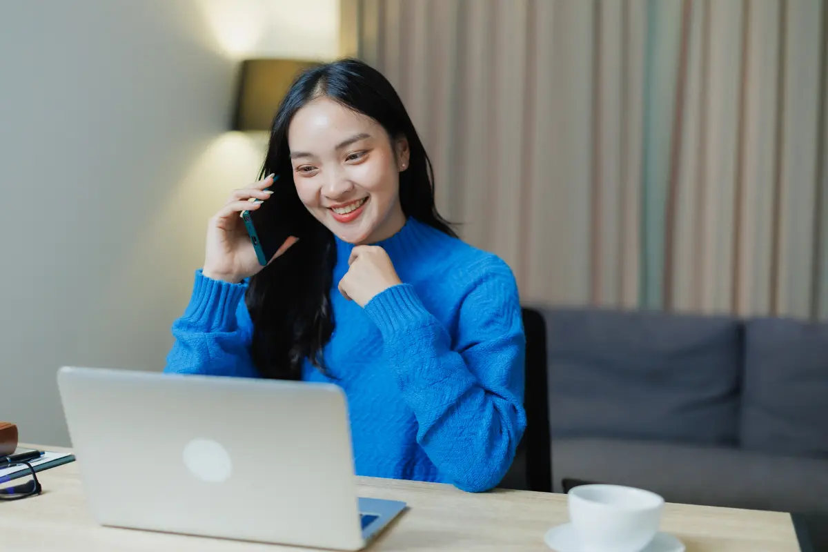 LLC owner happily completing IRS EIN application online to get a federal tax ID number and employer identification number for her new business