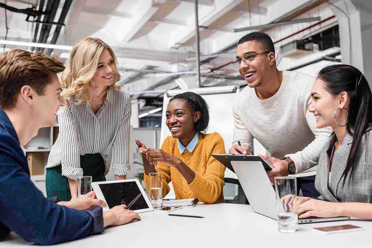 A group of smiling young colleagues having a meeting.