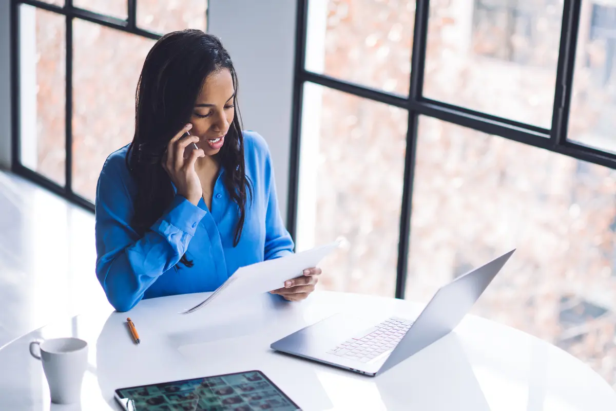 Small business owner reviewing documents while deciding between LLC and corporation business structure